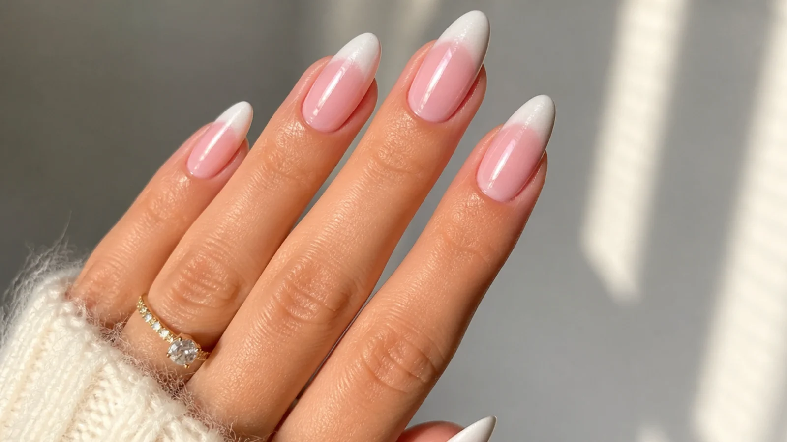 Pink to white ombre baby boomer nails finished with pearl chrome