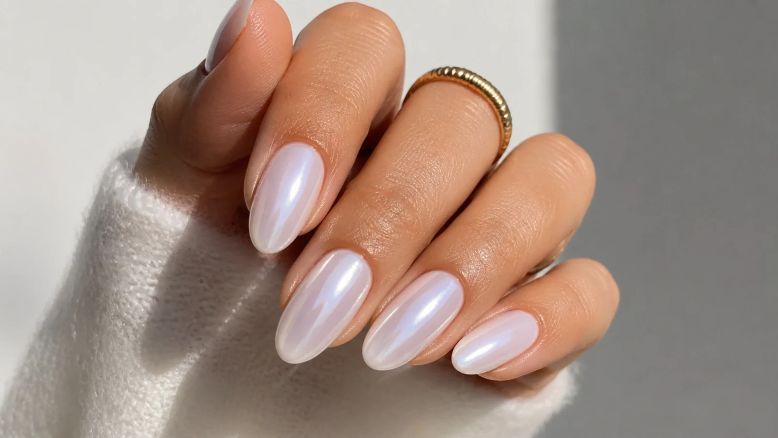 Glossy pearl white chrome glazed-donut nails on an almond shape