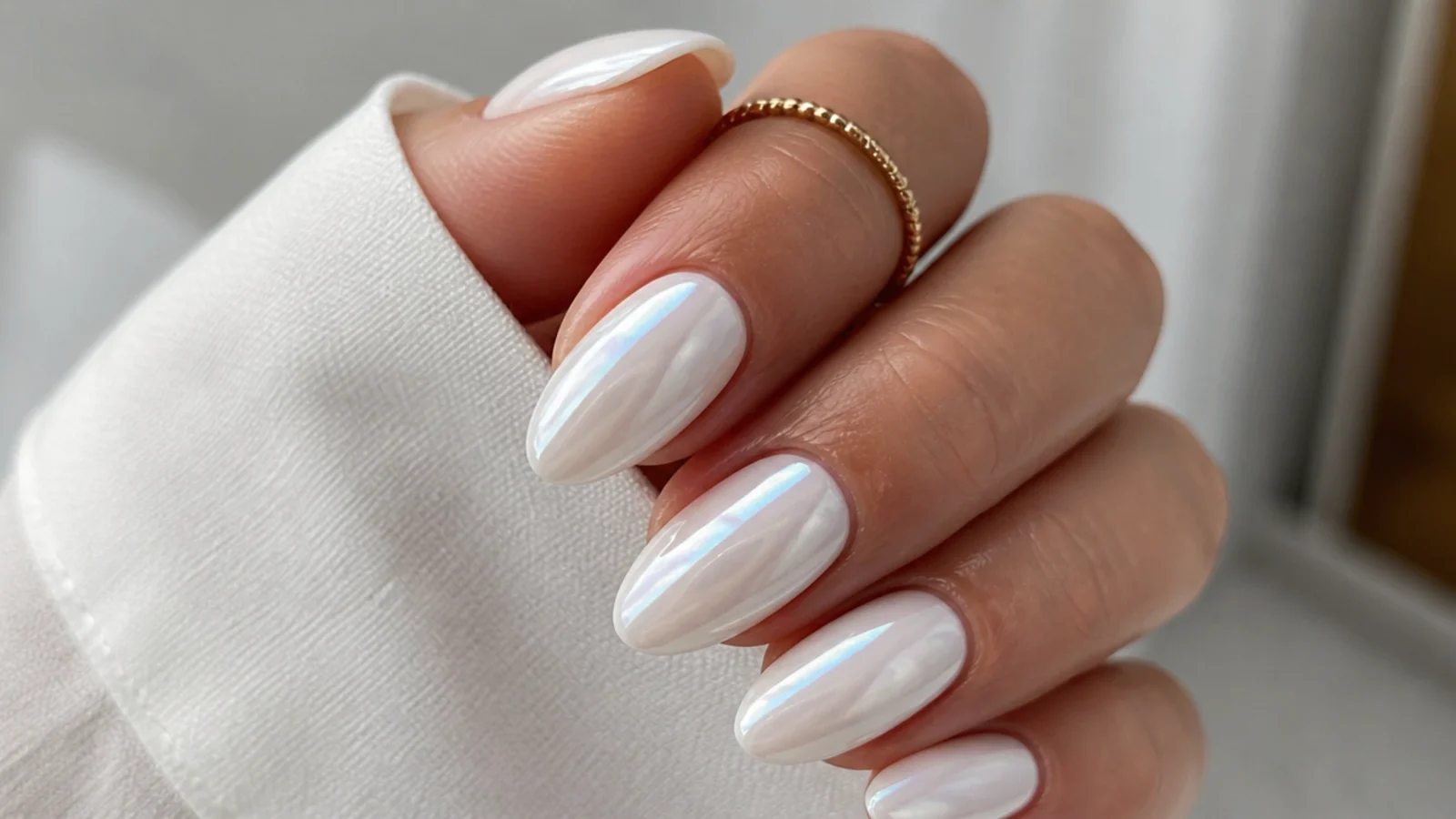 A well-sealed glossy white chrome manicure with cuticle oil for longevity