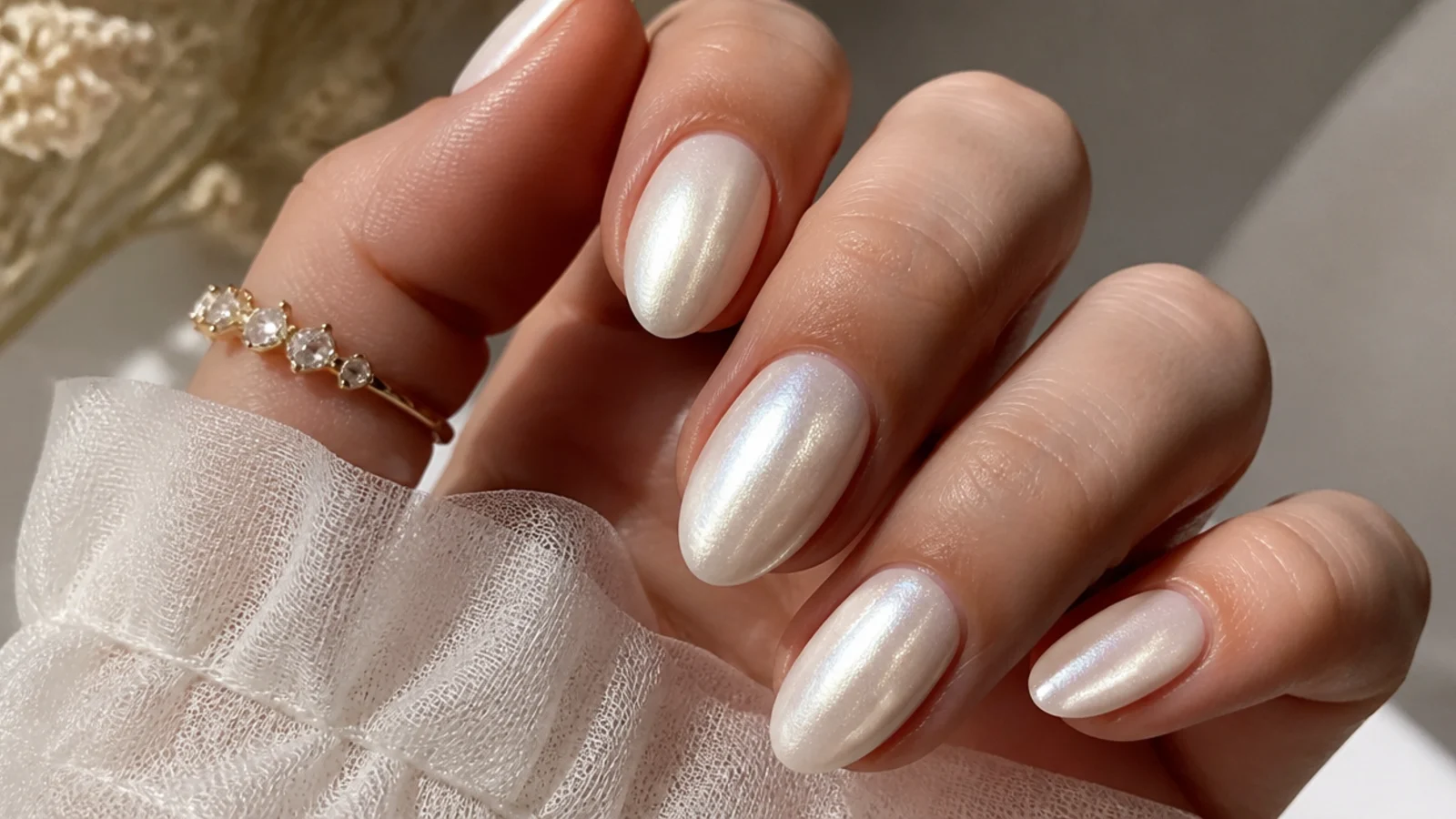Bridal milky white chrome nails with a full pearl shimmer on oval shapes