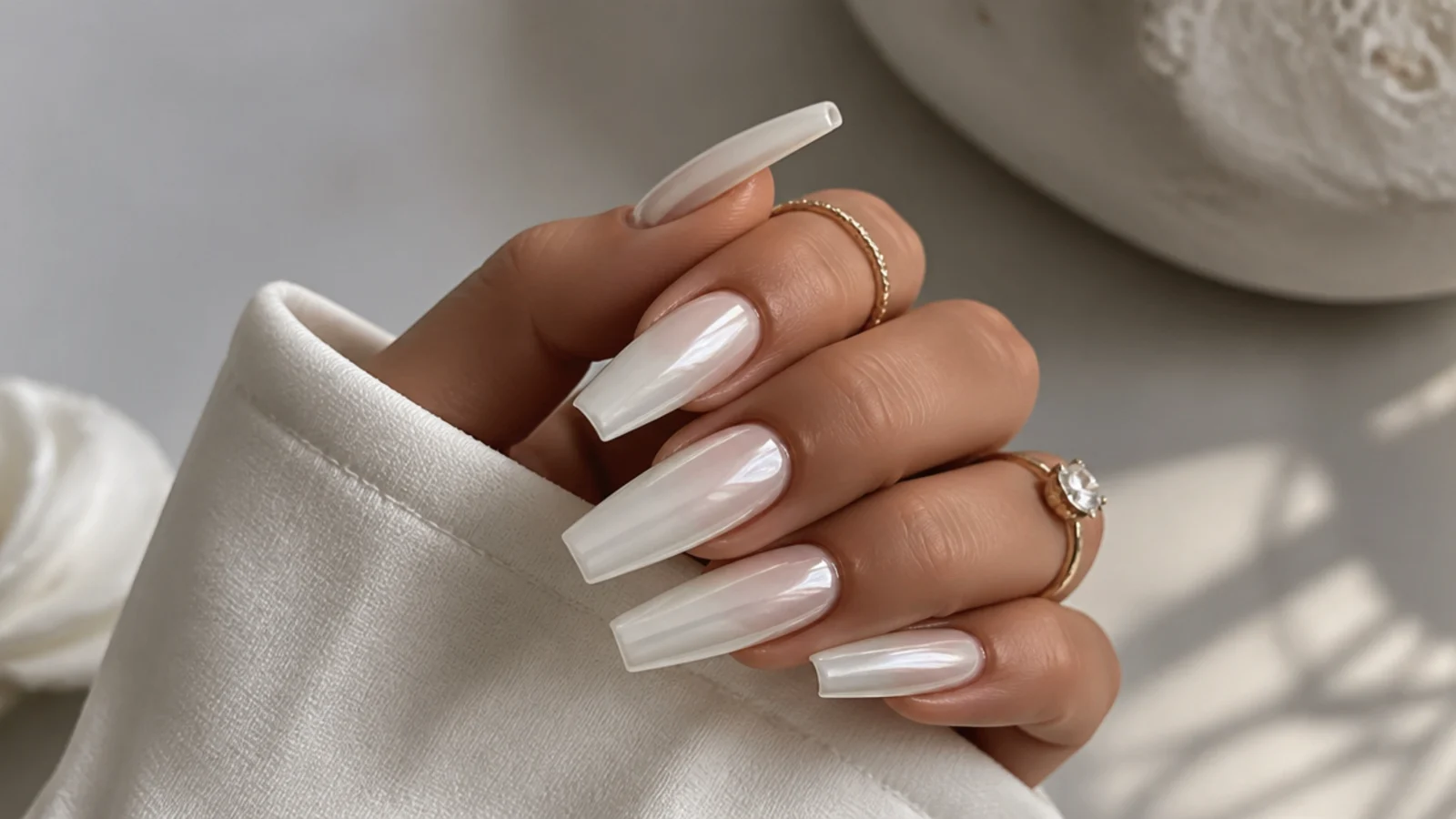 Long milky white chrome coffin nails with a full glazed pearl shine
