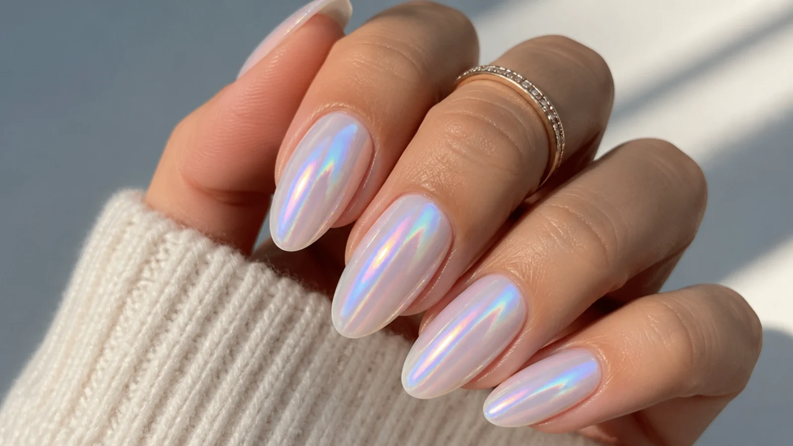 Off white chrome nails with a pink and blue aurora shimmer shift