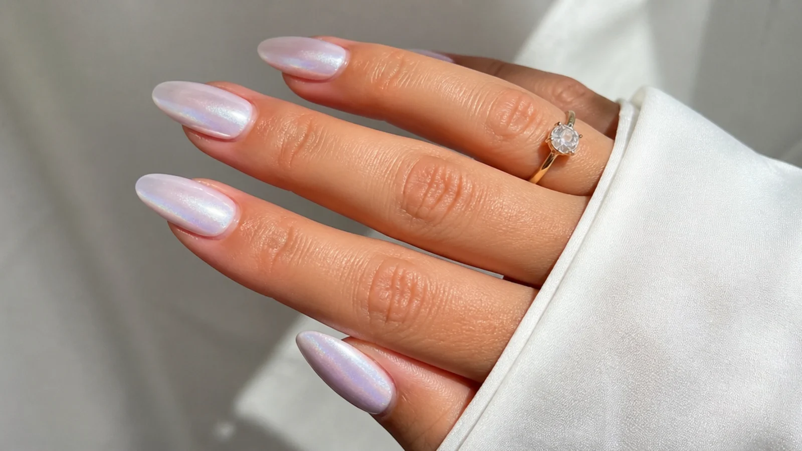 Soft bridal off white chrome nails with a delicate milky pearl glow