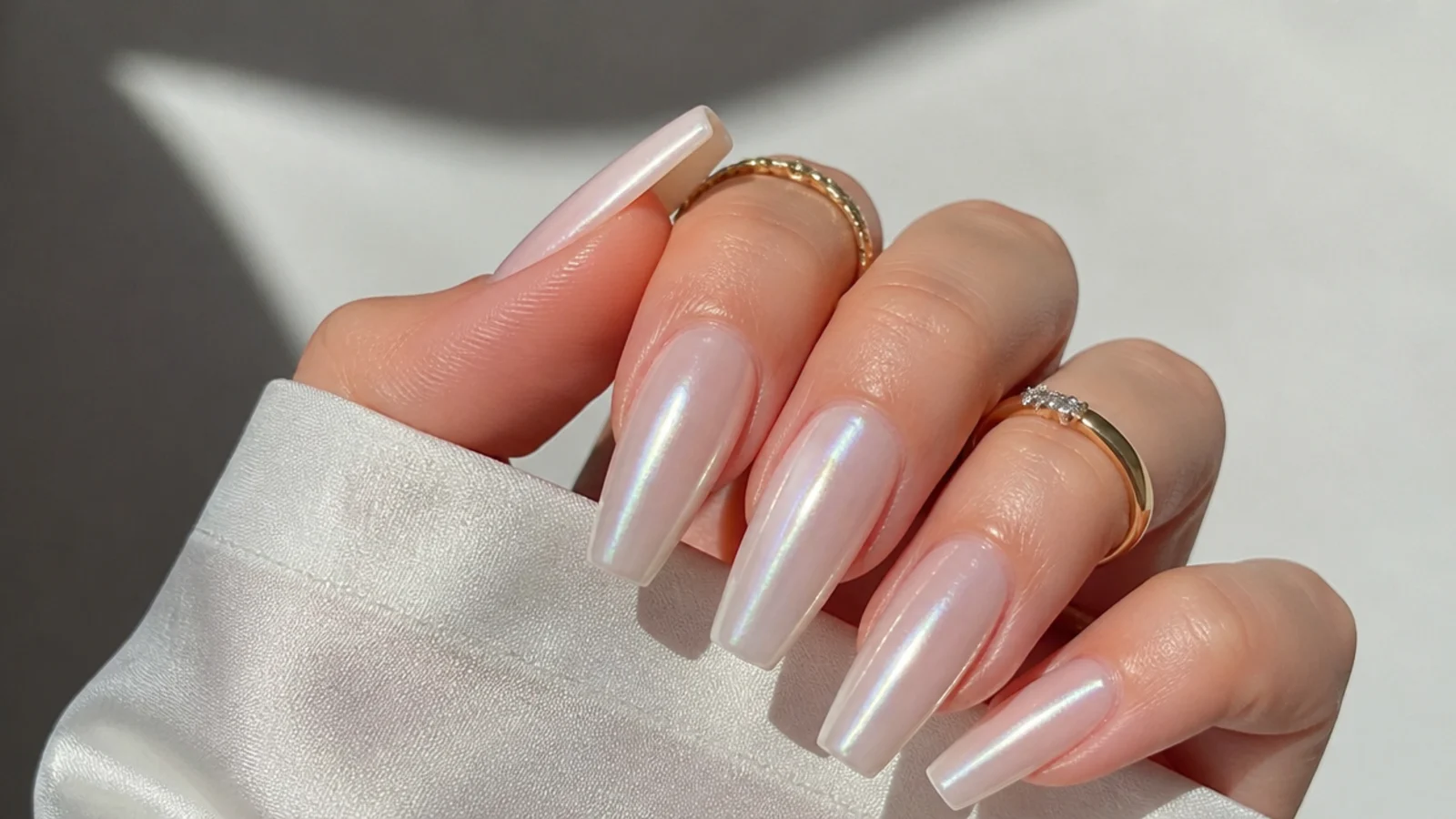 Long coffin pearl white chrome nails with a luminous glazed finish