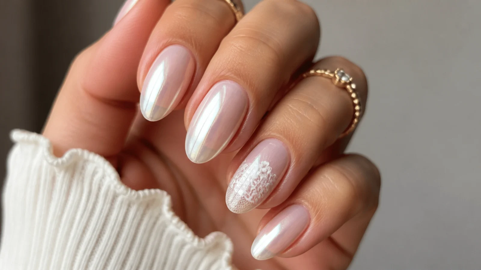 Milky pearl chrome nails with a fine white lace detail on one nail