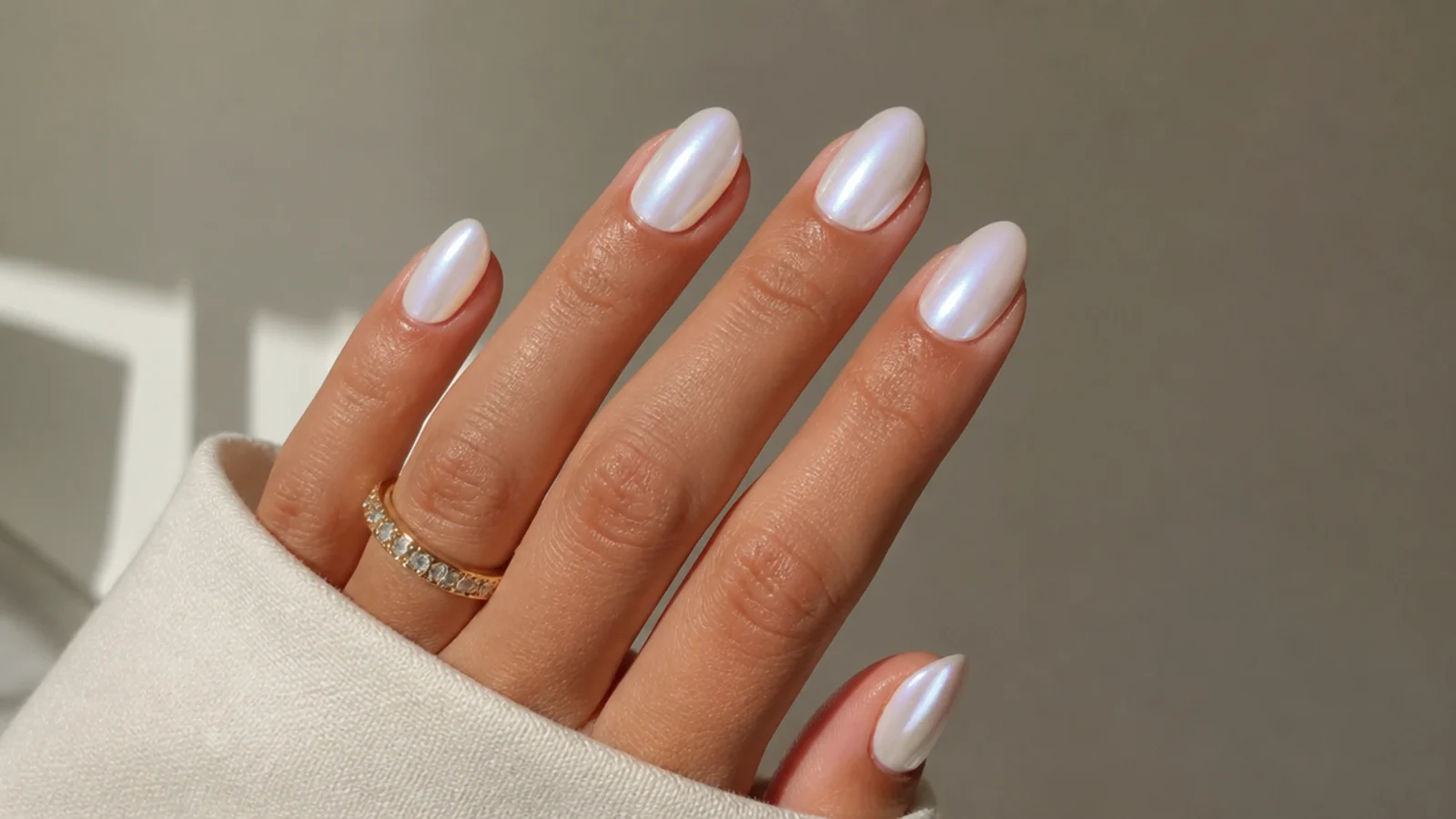 Short almond white chrome nails with a soft pearl glow