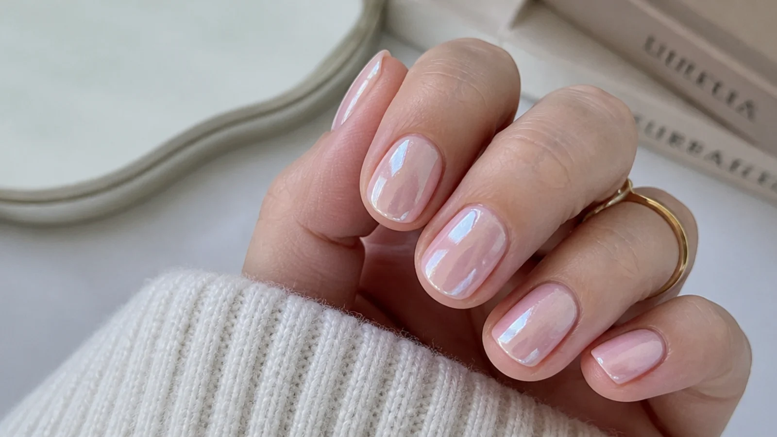 Short milky pearl glazed-donut nails catching soft light