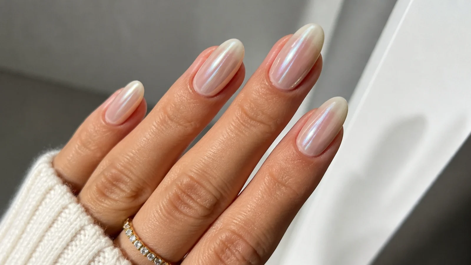 Sheer nude almond nails with a pearl white chrome overlay