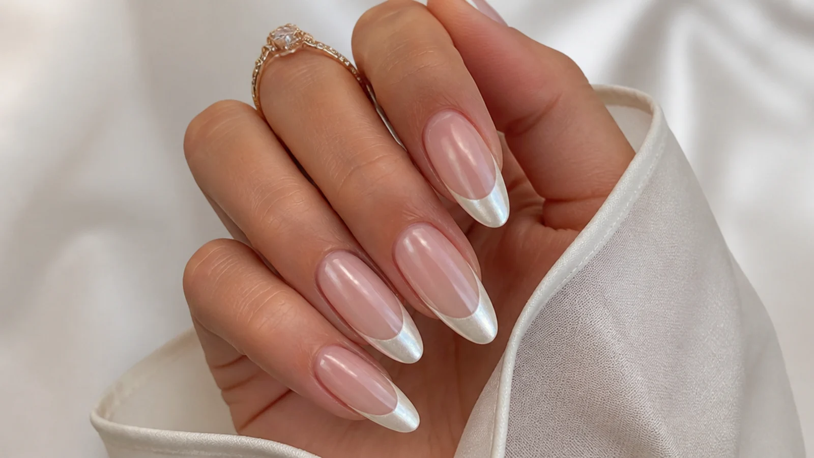 Long almond nails with a bright white pearl chrome french tip for a wedding