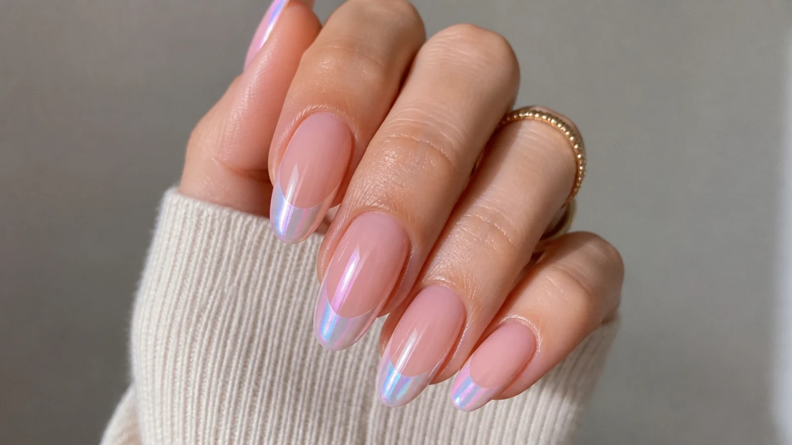 Almond nails with a pearl french tip flashing pink and blue aurora chrome