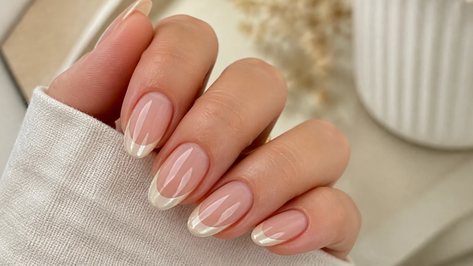 Almond nails with a warm off-white cream chrome french tip