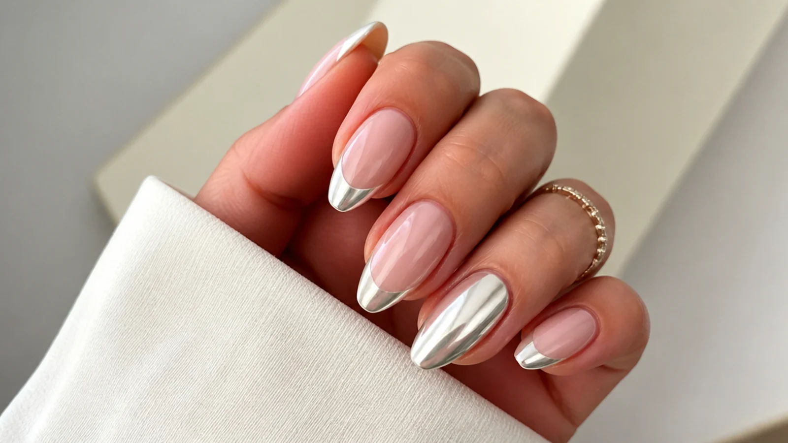 Almond nails with pearl chrome french tips and one fully chromed accent nail