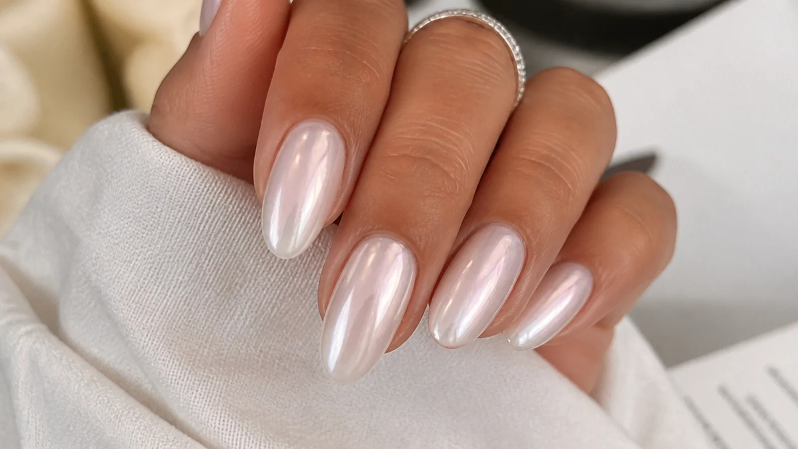 A milky pearl chrome nail with the lit, dewy glazed-donut glow