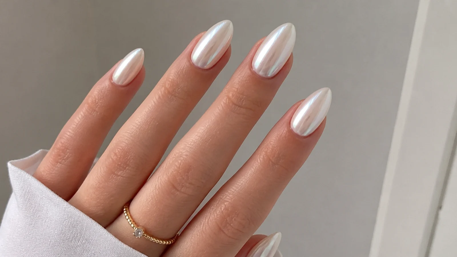 Medium almond nails with a full milky white chrome finish