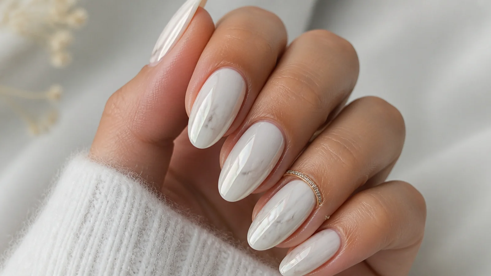 White chrome nails with soft gray marble veining under the pearl