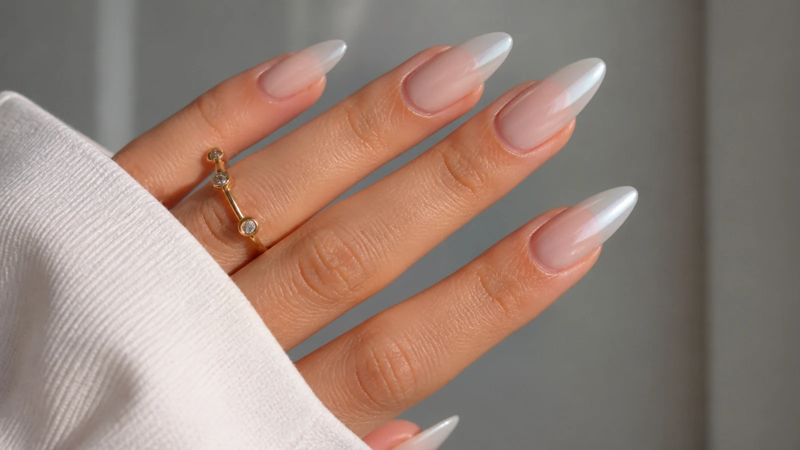 Nails fading from sheer nude base to milky white chrome tips
