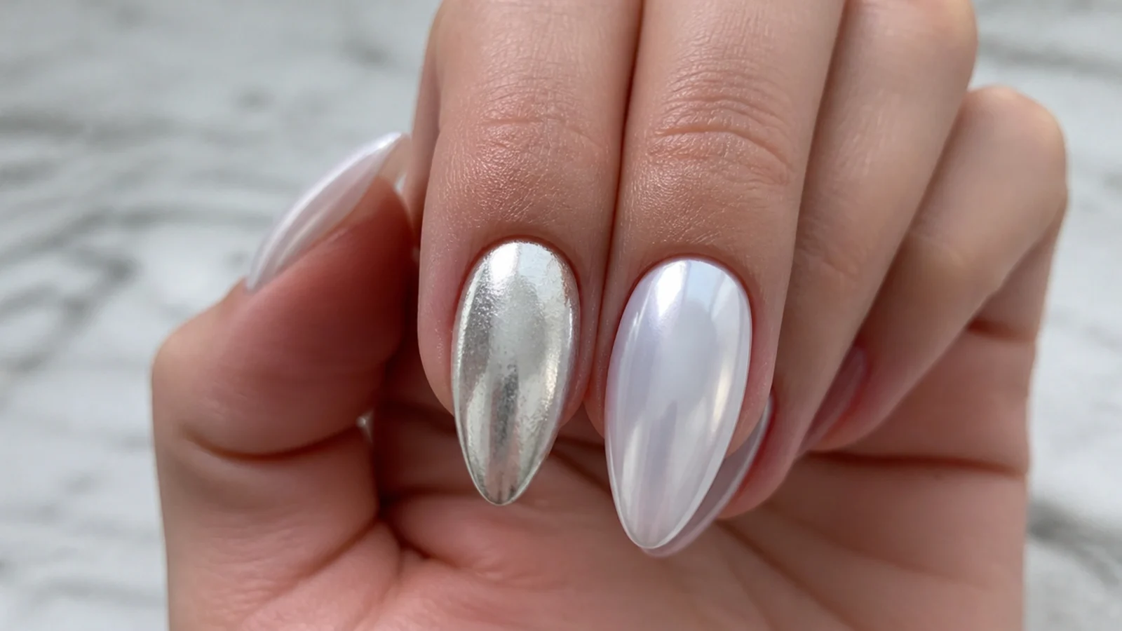 A dull patchy chrome nail beside a smooth glassy white chrome nail