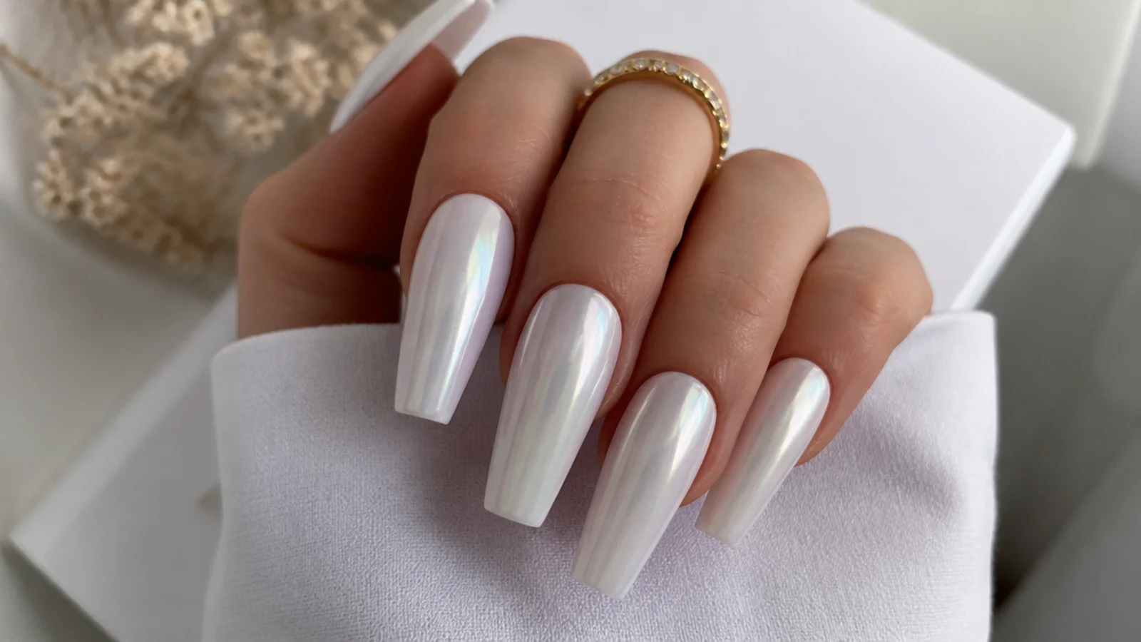 Long milky-white pearl chrome nails on a full coffin shape