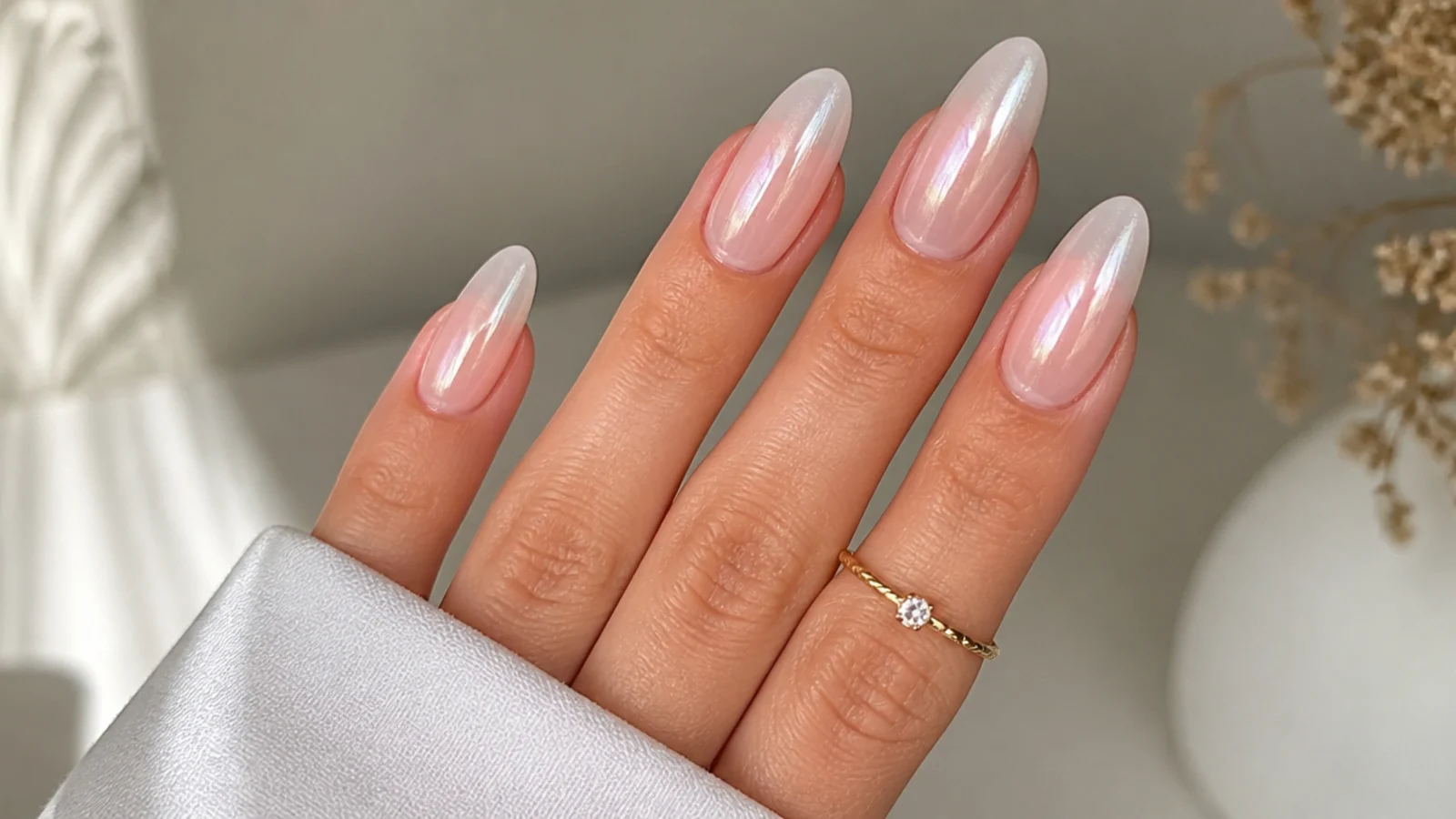 Pink-to-white baby boomer nails finished with a pearl chrome glaze