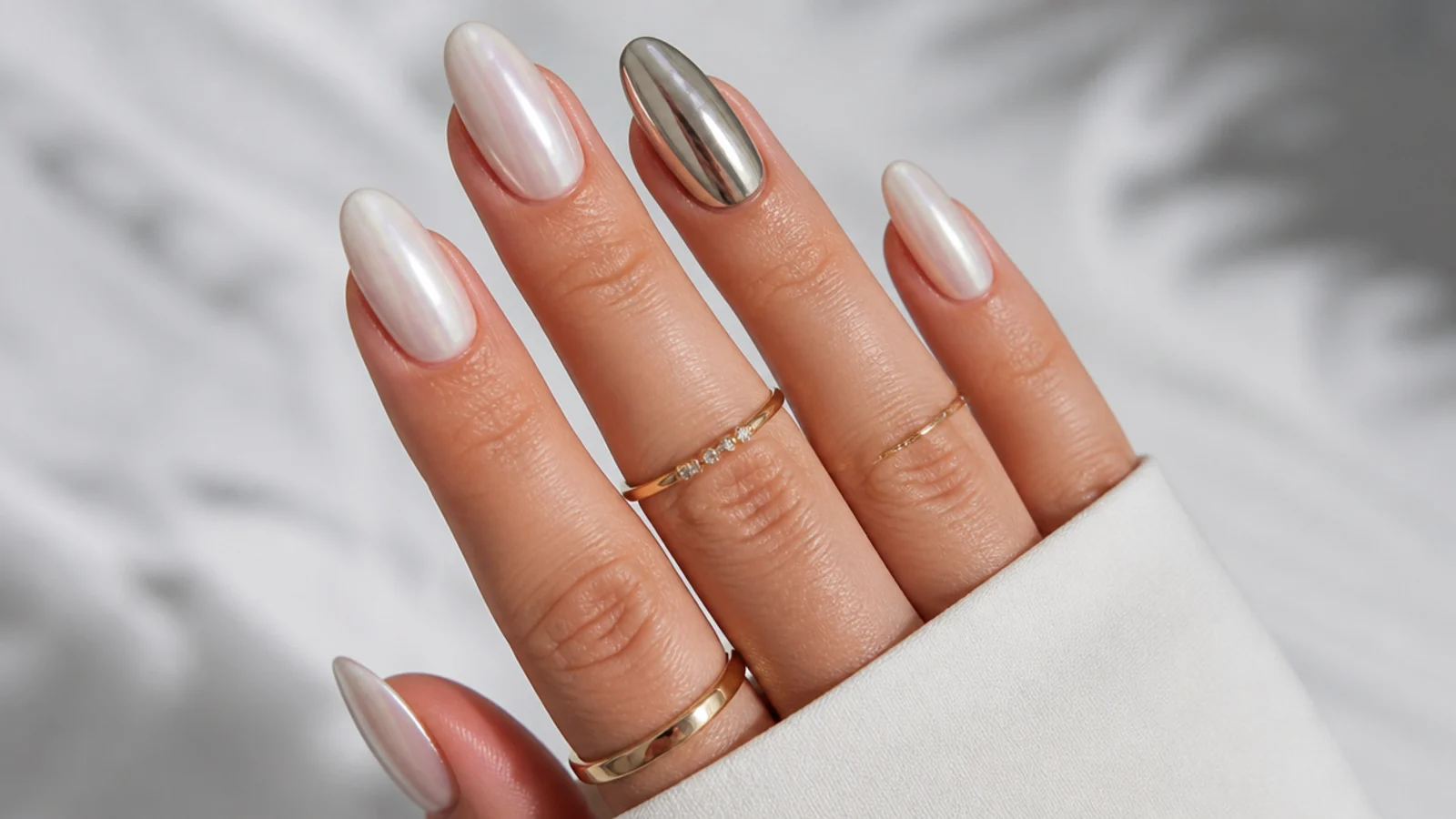 Nails mixing soft pearl white chrome with one mirror silver chrome accent