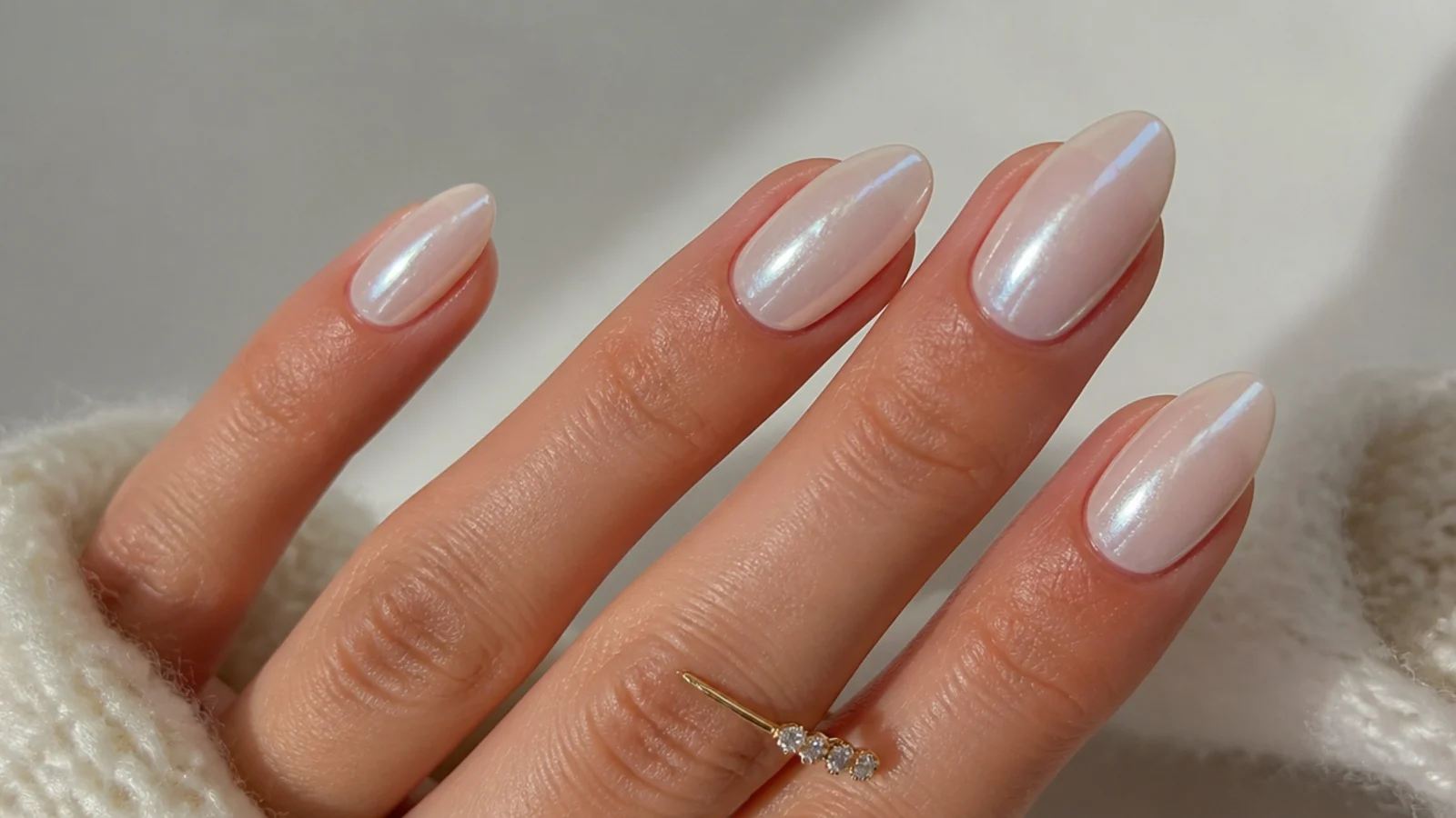 Glassy pearl white chrome wedding nails on an almond shape with a glazed-donut sheen
