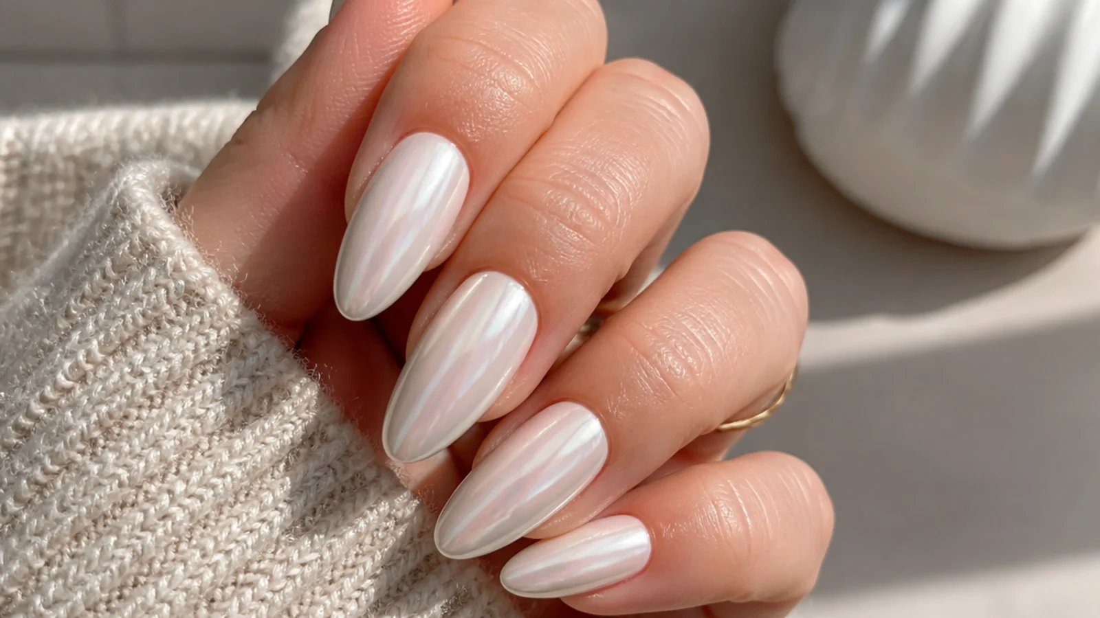 Long almond white chrome nails with a full glassy pearl glaze