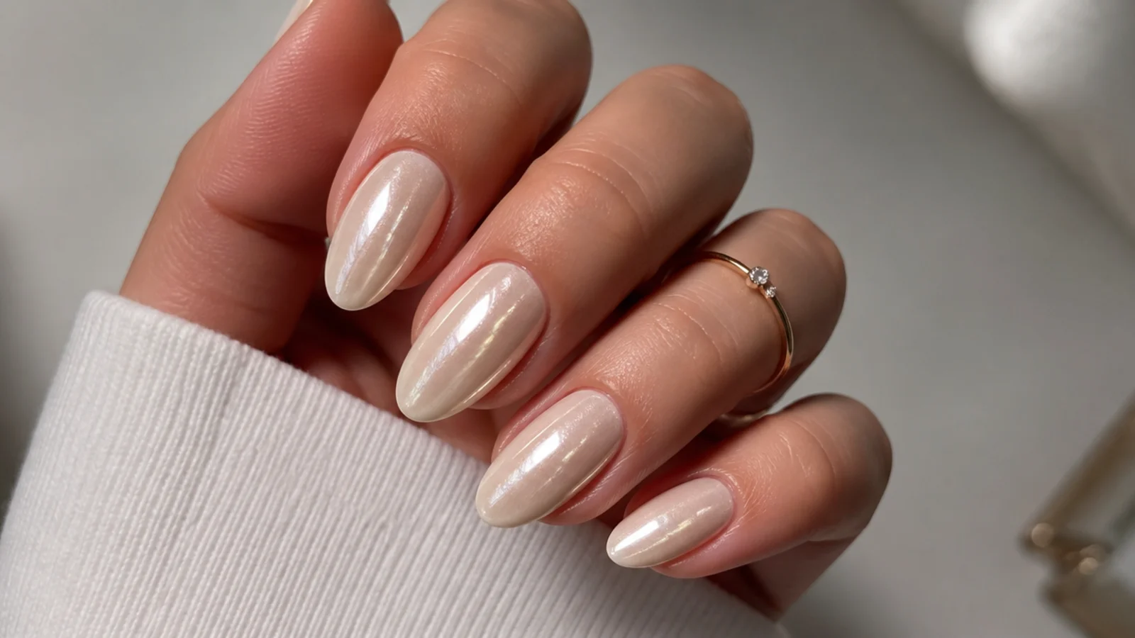 Warm off-white cream chrome nails with a soft pearl glow