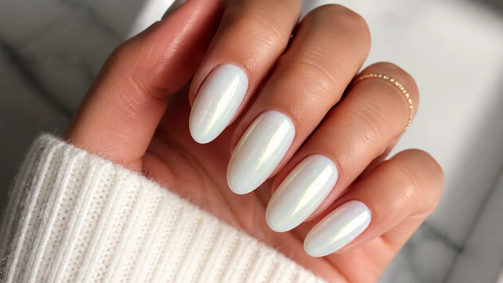 White chrome nails with a milky opal moonstone glow and soft color flecks