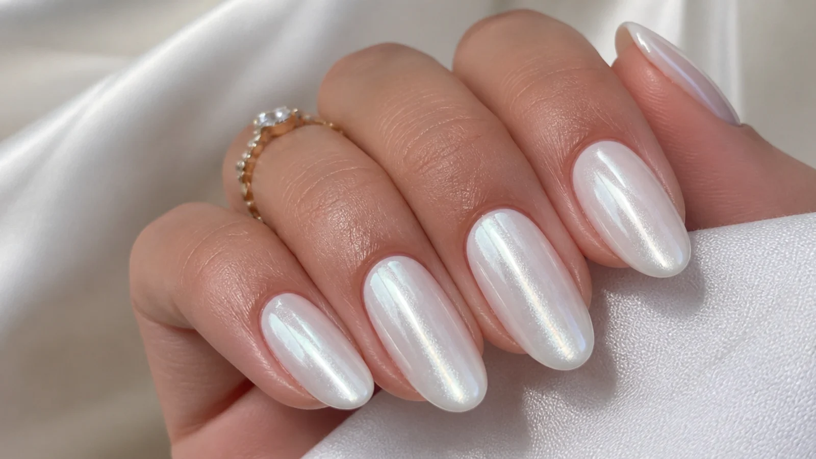 White chrome nails with a soft pearl cat-eye light strip