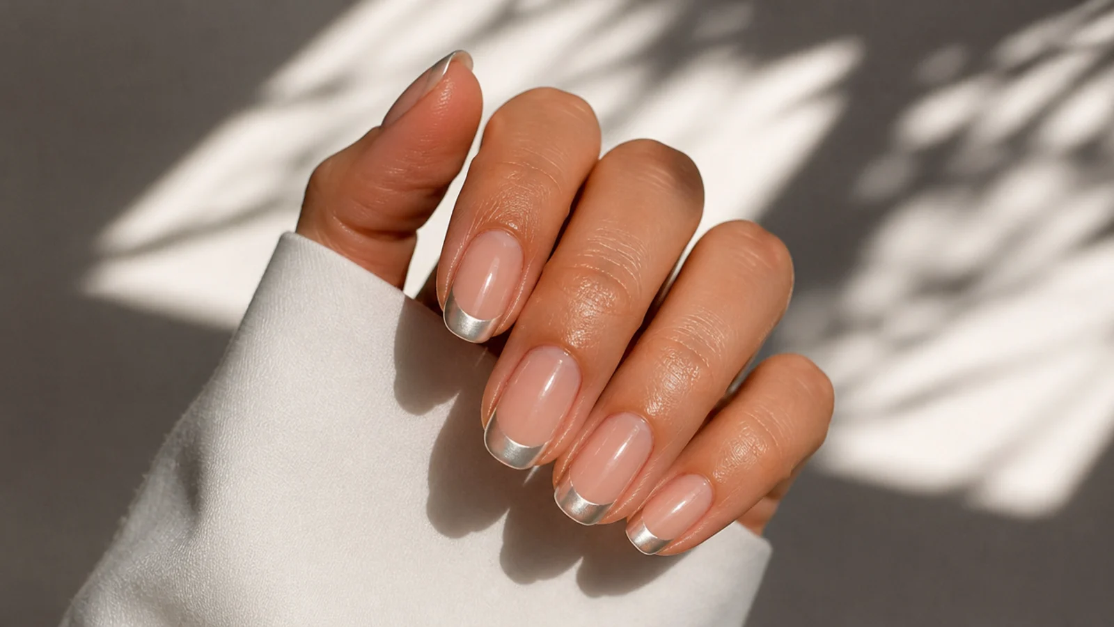 Nearly clear nails with pearl white chrome painted only on the tips