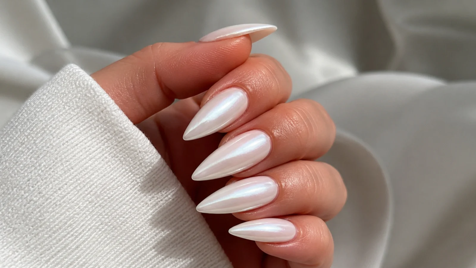 Long pointed stiletto white chrome nails with a full pearl glaze