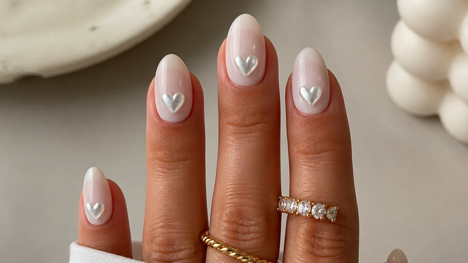 Milky white nails with small pearl chrome heart accents