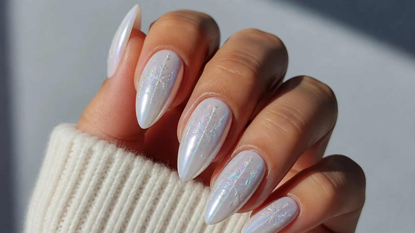 Icy frosted white chrome nails with a cool blue-white pearl glow