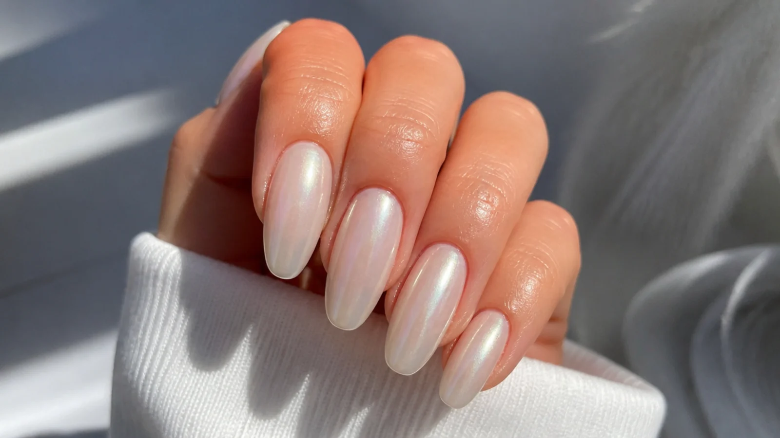 A well-sealed pearl white chrome manicure with cuticle oil for longevity