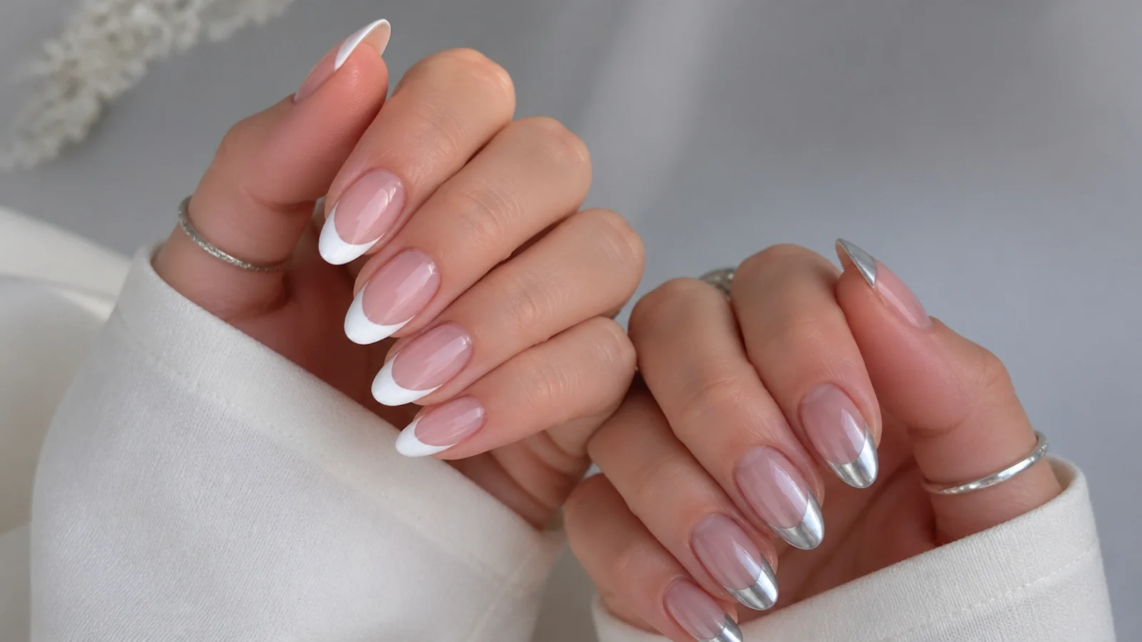 White chrome french tip nails beside silver chrome french tip nails on a nude base