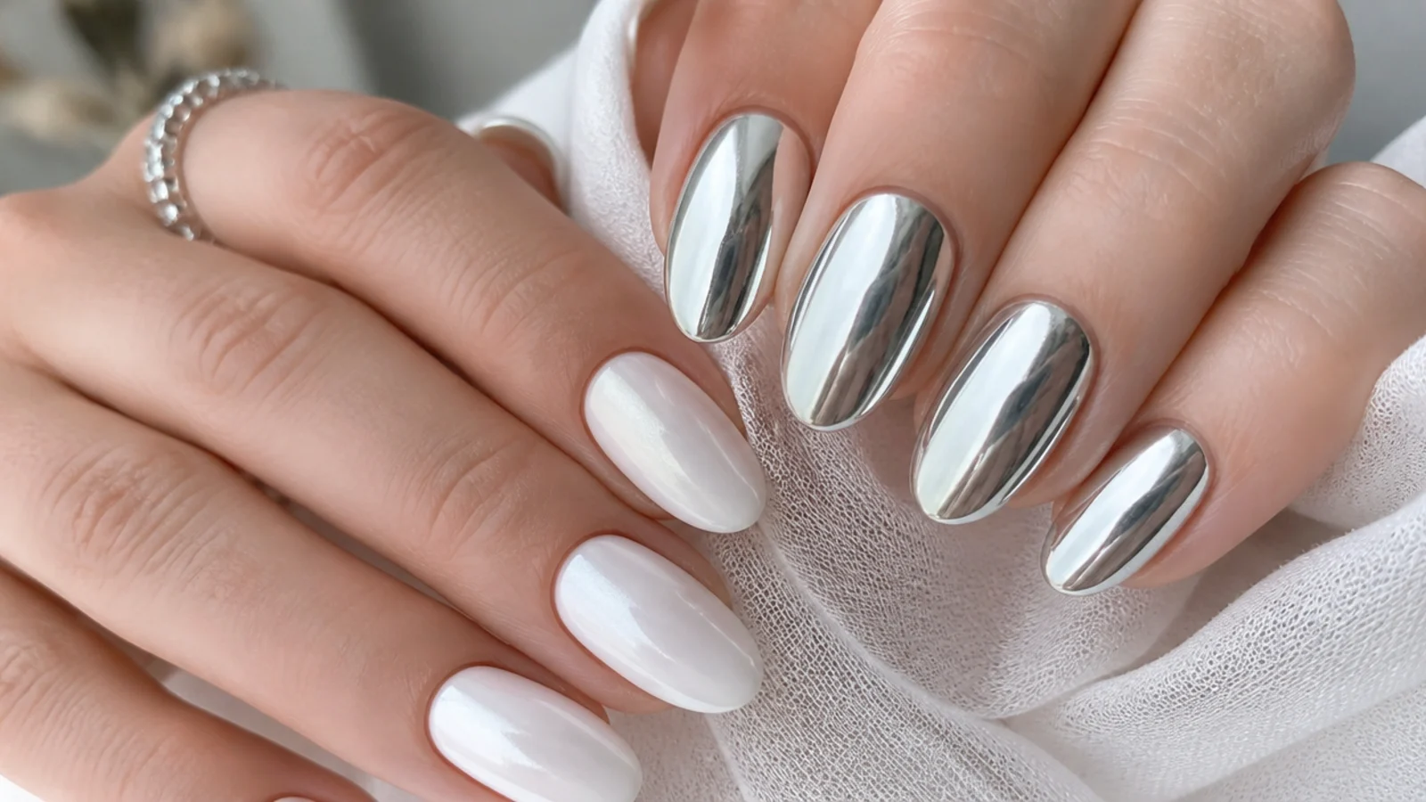 Soft matte-look white chrome nails beside high-shine silver mirror chrome nails