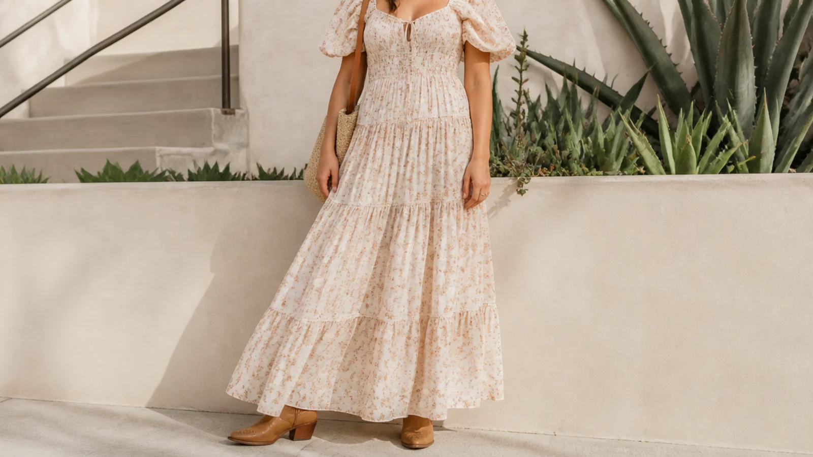 Faceless summer outfit with a flowy maxi dress and tan western ankle boots peeking at the hem