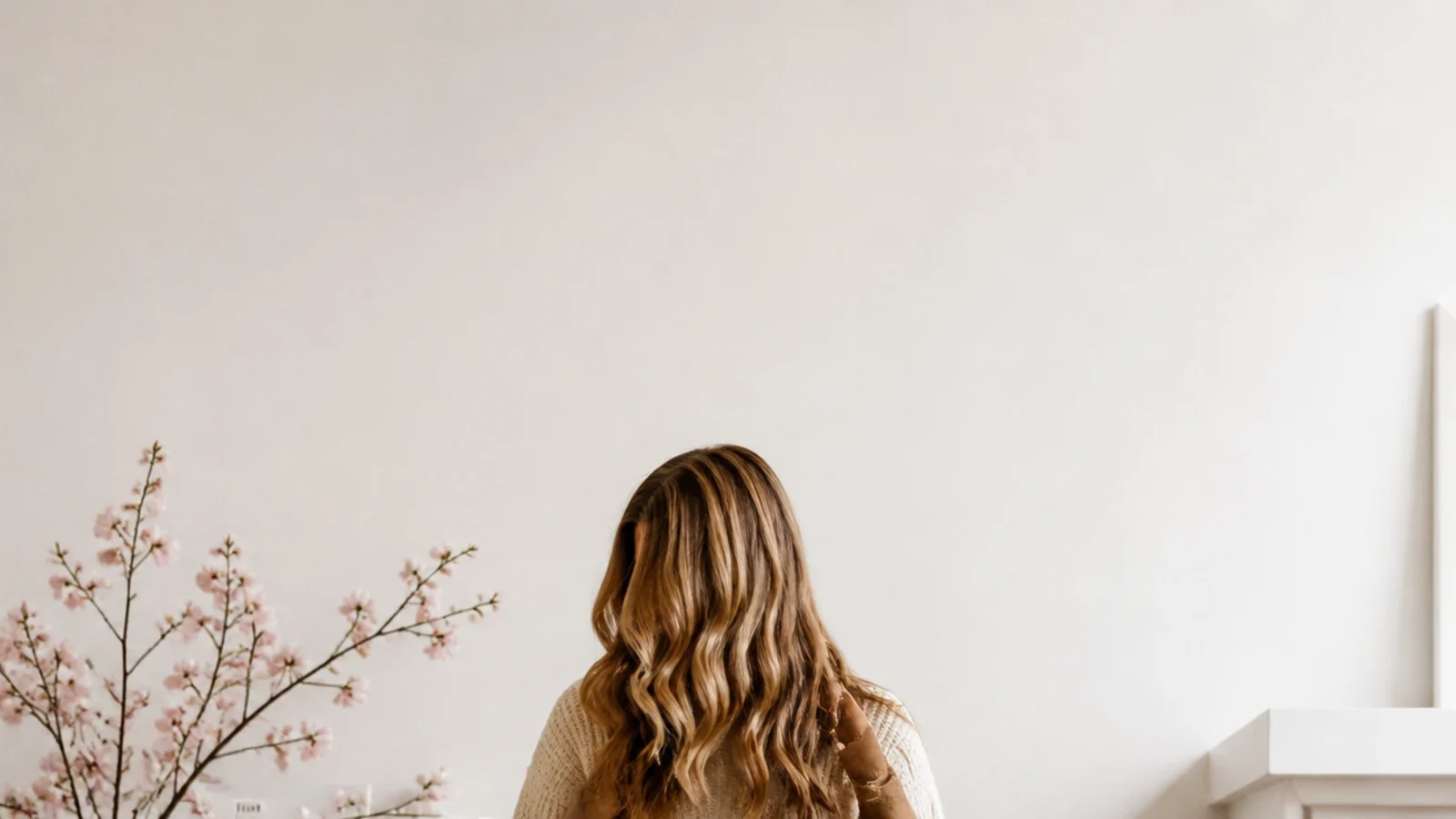 Faceless beige outfit formula with a cream sweater, sand jeans and tan boots arranged as a repeatable look