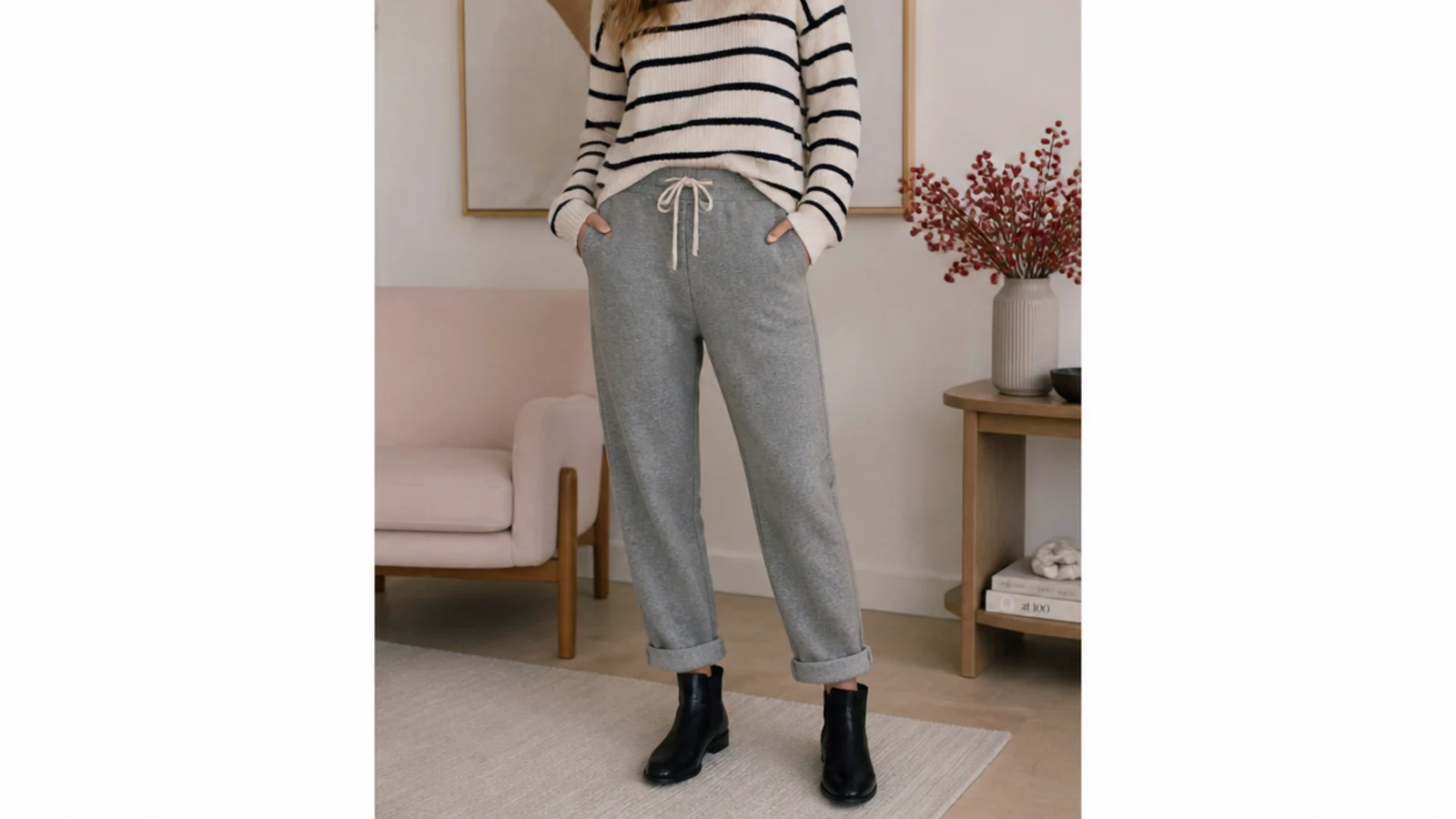 Faceless casual outfit with cuffed gray sweatpants and low black leather ankle boots