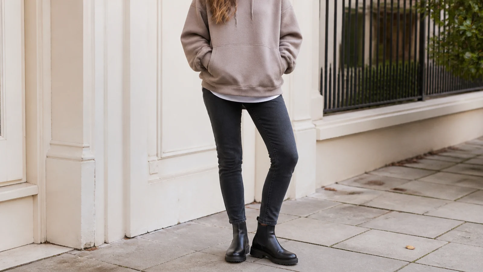 Faceless casual outfit with an oversized hoodie, slim jeans and black leather Chelsea boots