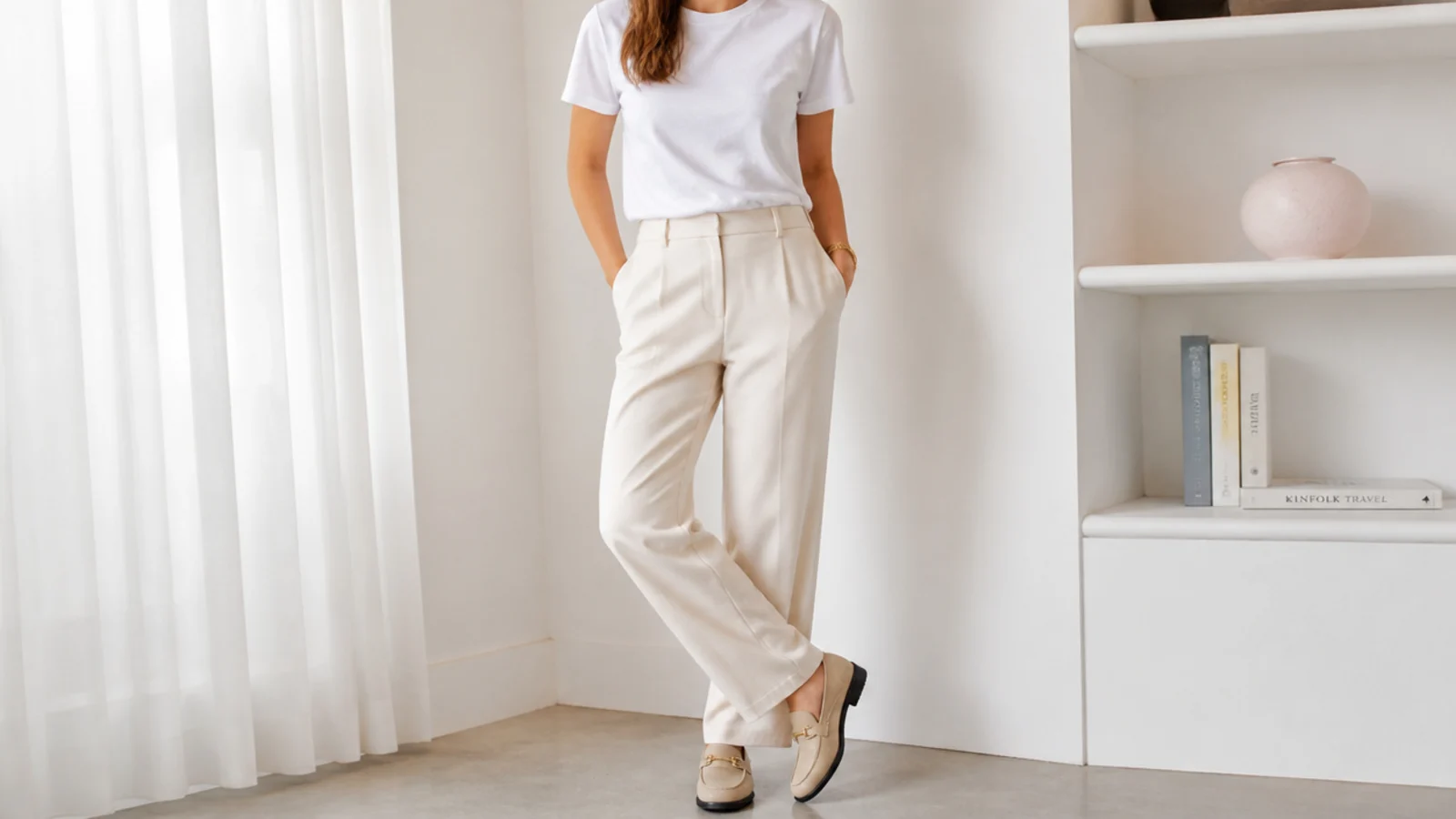 Faceless outfit with a plain white cotton crewneck tee tucked into ecru tailored trousers with loafers