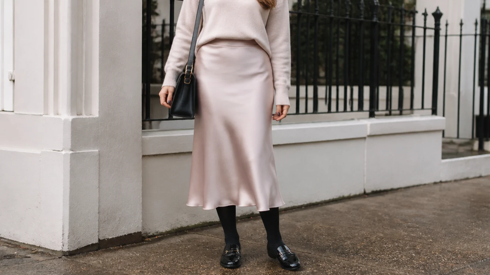 Faceless outfit with a satin-look midi skirt, opaque tights, a tucked knit and black waterproof loafers