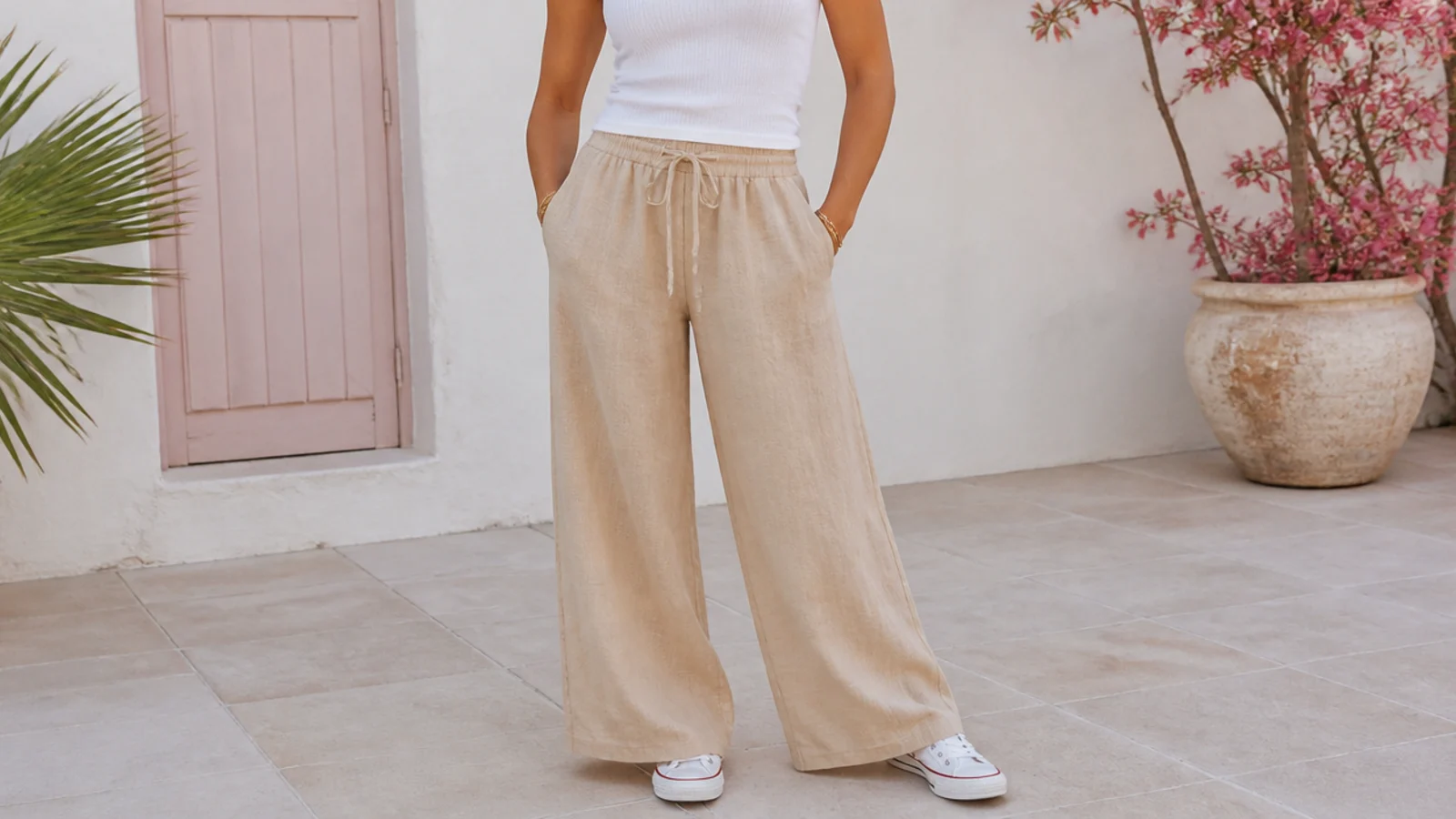 Faceless summer outfit with wide-leg linen pants, a fitted tank and low white canvas sneakers