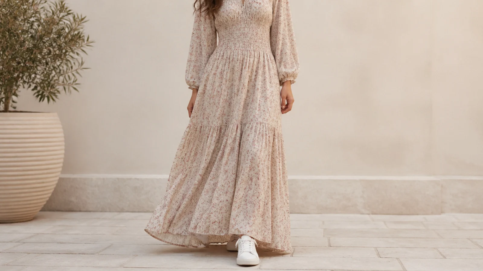 Faceless full-length shot of a flowing maxi dress with a low white leather sneaker peeking out