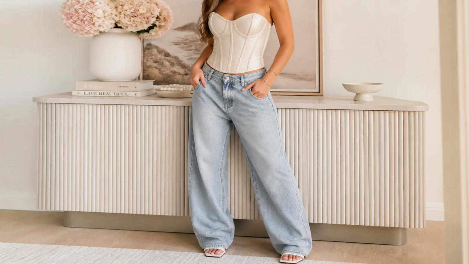 Faceless waist-up shot of a soft lightly boned stretch corset top with baggy jeans for everyday wear