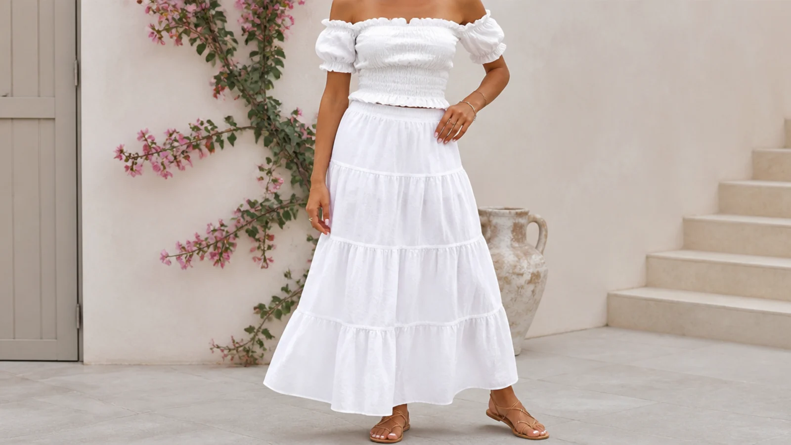 Faceless outfit with a white tiered cotton maxi skirt, a white off-shoulder top and tan strappy flat sandals