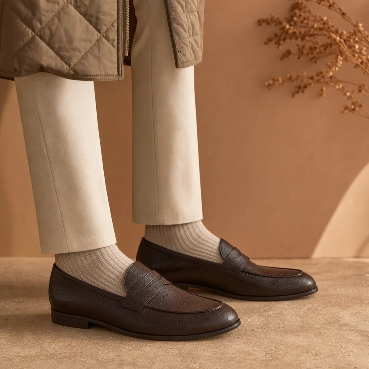 Faceless full-length shot of a smart quilted coat over trousers with water-resistant loafers for commuting
