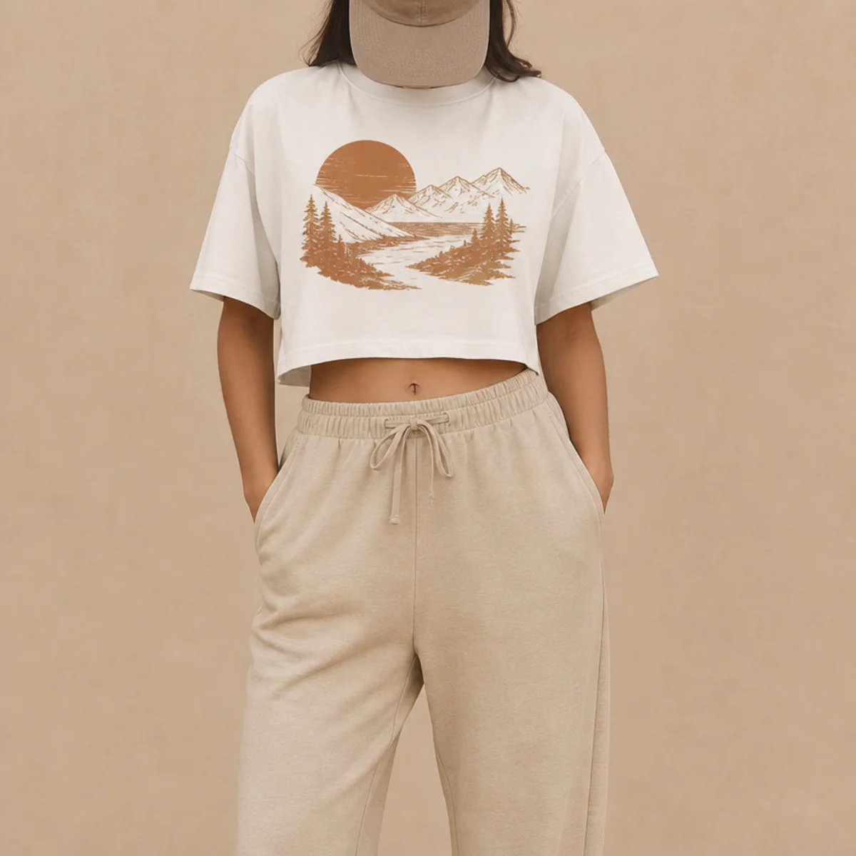 Faceless waist-up shot of a cropped graphic tee with joggers and a baseball cap for campus
