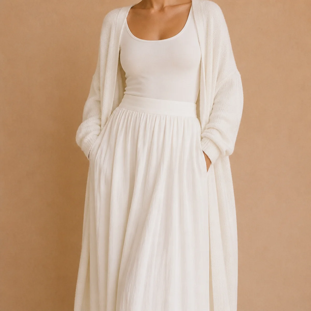 Faceless waist-up shot of a white maxi skirt with a fitted tank and a draped cardigan