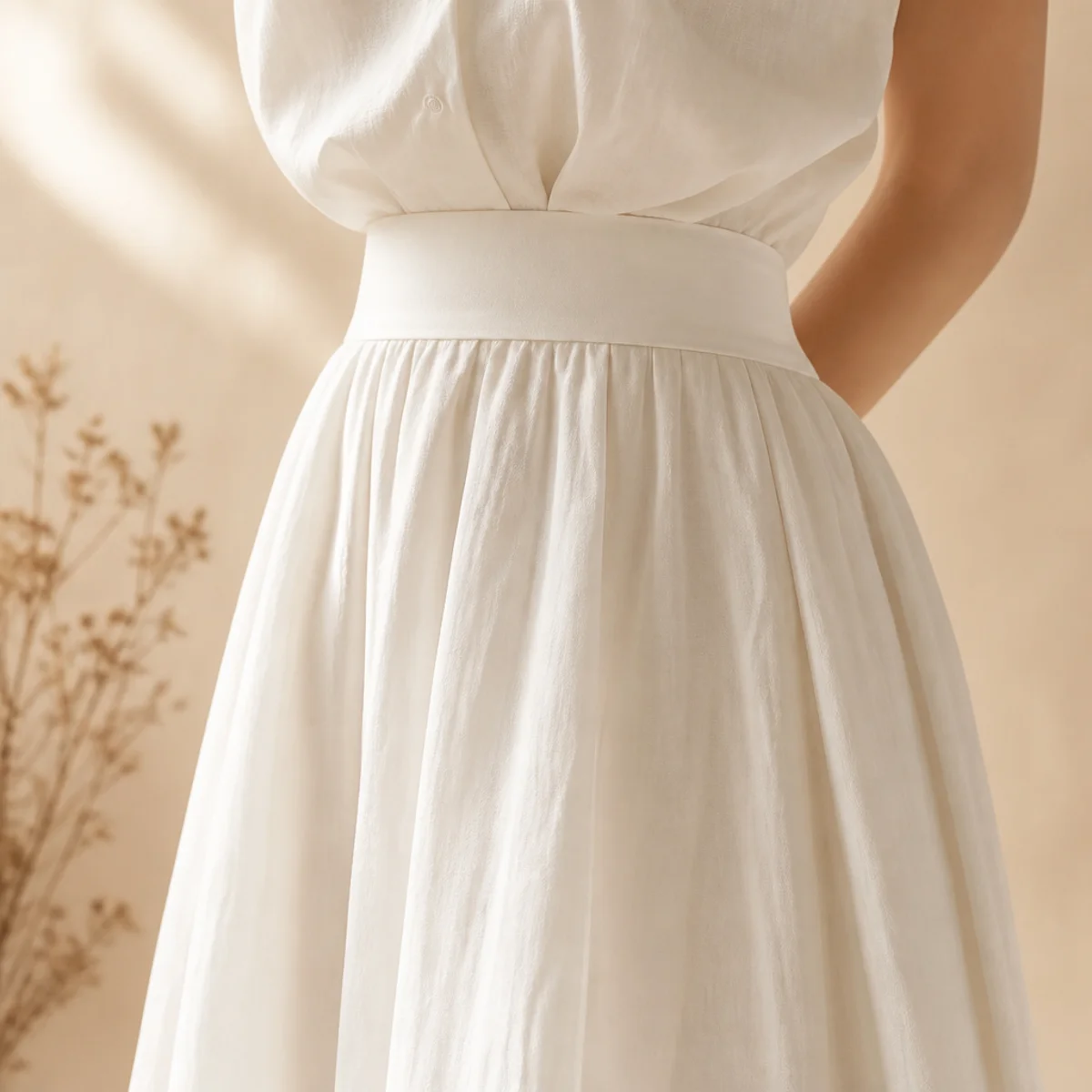 Faceless full-length shot of an all-white outfit with a white skirt and white top